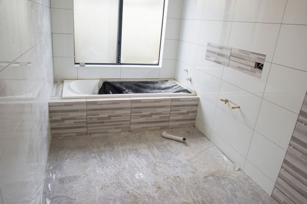 Applying Tiles on Bathroom - Elevare Builders LLC Albuquerque, NM